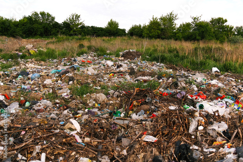 A landfill site with garbage and debris in the background. Environmental pollution caused by landfill waste. Trash and debris on a landfill background. environmental pollution and waste management