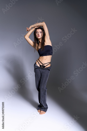 Young woman in chic attire posing confidently.