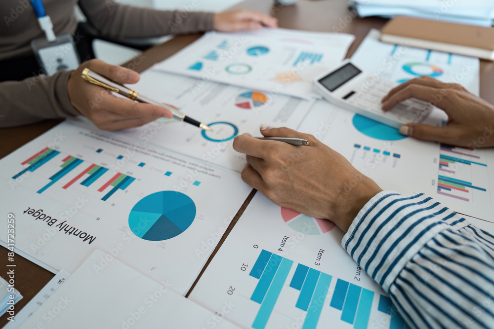 Business Team Analyzing Financial Graphs and Charts, High-Angle View Concept of financial analysis and teamwork Business Team Analyzing Financial Graphs and Charts, High-Angle View Concept of financial analysis and teamwork