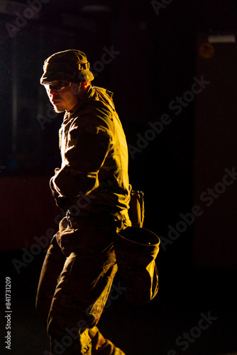 at a professional shooting range military ammunition trainer stands aiming a pistol © Guys Who Shoot