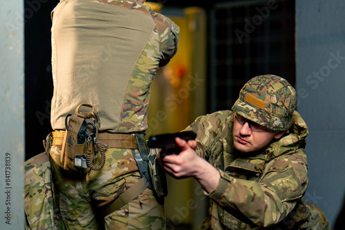 Tablou pe pânză At a professional shooting range two military trainers perform tactical exercise