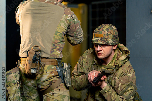 Tablou pe pânză At a professional shooting range two military trainers perform tactical exercise