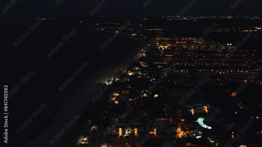 Scenic Aerial View from Drone of Touristic Coastal City Against a Spectacular Purple Sunset Sky, Illuminated by Vibrant City Lights. Ocean. Caribbean Sea Scenic Aerial View from Drone of Touristic Coastal City Against a Spectacular Purple Sunset Sky, Illuminated by Vibrant City Lights. Ocean. Caribbean Sea