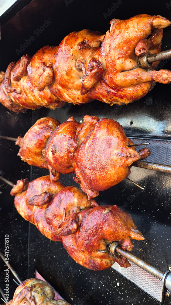 Rustic whole chicken on the restaurant's grill prepared for hot and crispy lunch and dinner Rustic whole chicken on the restaurant's grill prepared for hot and crispy lunch and dinner