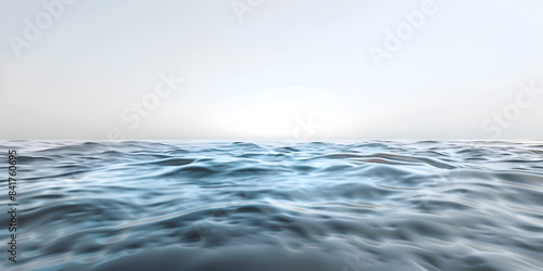 Sea water with waves crashing against the shore, illuminated by the warm glow of the sun in the background