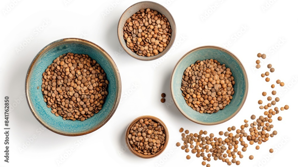 Top and side views of bowls with uncooked lentils on a white background Top and side views of bowls with uncooked lentils on a white background
