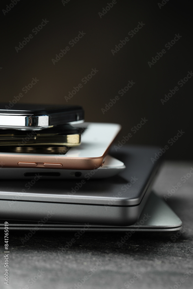 Stack of electronic devices on grey table, closeup Stack of electronic devices on grey table, closeup