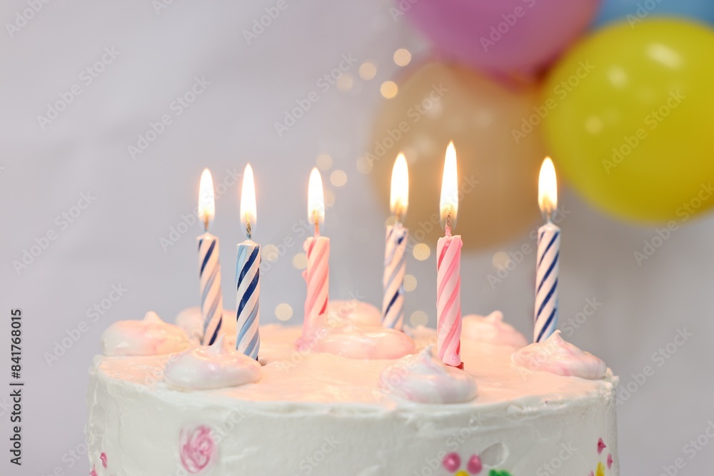Tasty Birthday cake with burning candles against blurred background, closeup Tasty Birthday cake with burning candles against blurred background, closeup