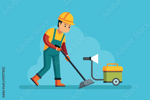 an indoor worker vacuuming the floor with an electric vacuum cleaner. The foreman is wearing a helmet, safety goggles and overalls, indicating compliance with safety measures.