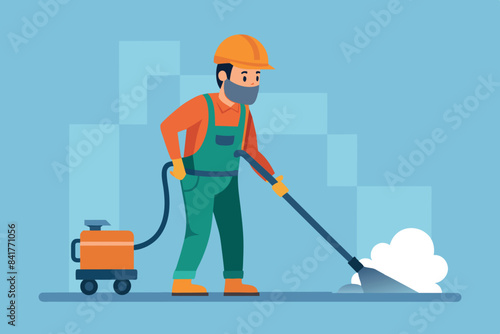 an indoor worker vacuuming the floor with an electric vacuum cleaner. The foreman is wearing a helmet, safety goggles and overalls, indicating compliance with safety measures.