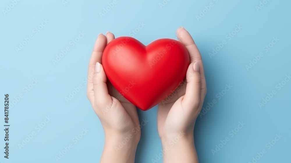Female hand holding gift box with red heart isolated Female hand holding gift box with red heart isolated