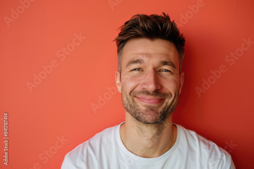 A close up portrait of a young man with a subtle smile