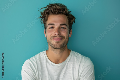 A close up portrait of a young man with a subtle smile