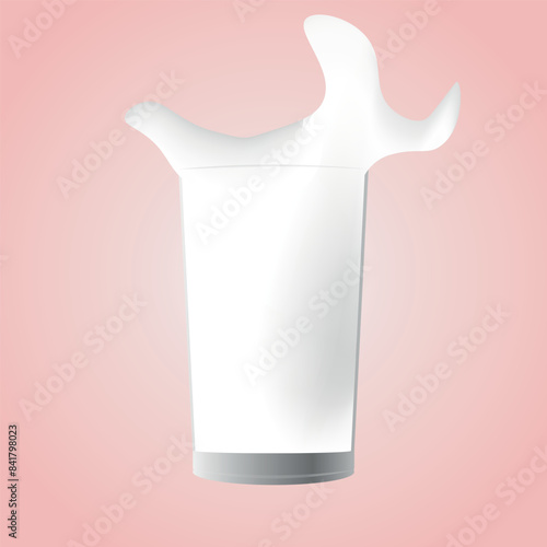 A glass of milk in the pink background. milk splashing in a glass