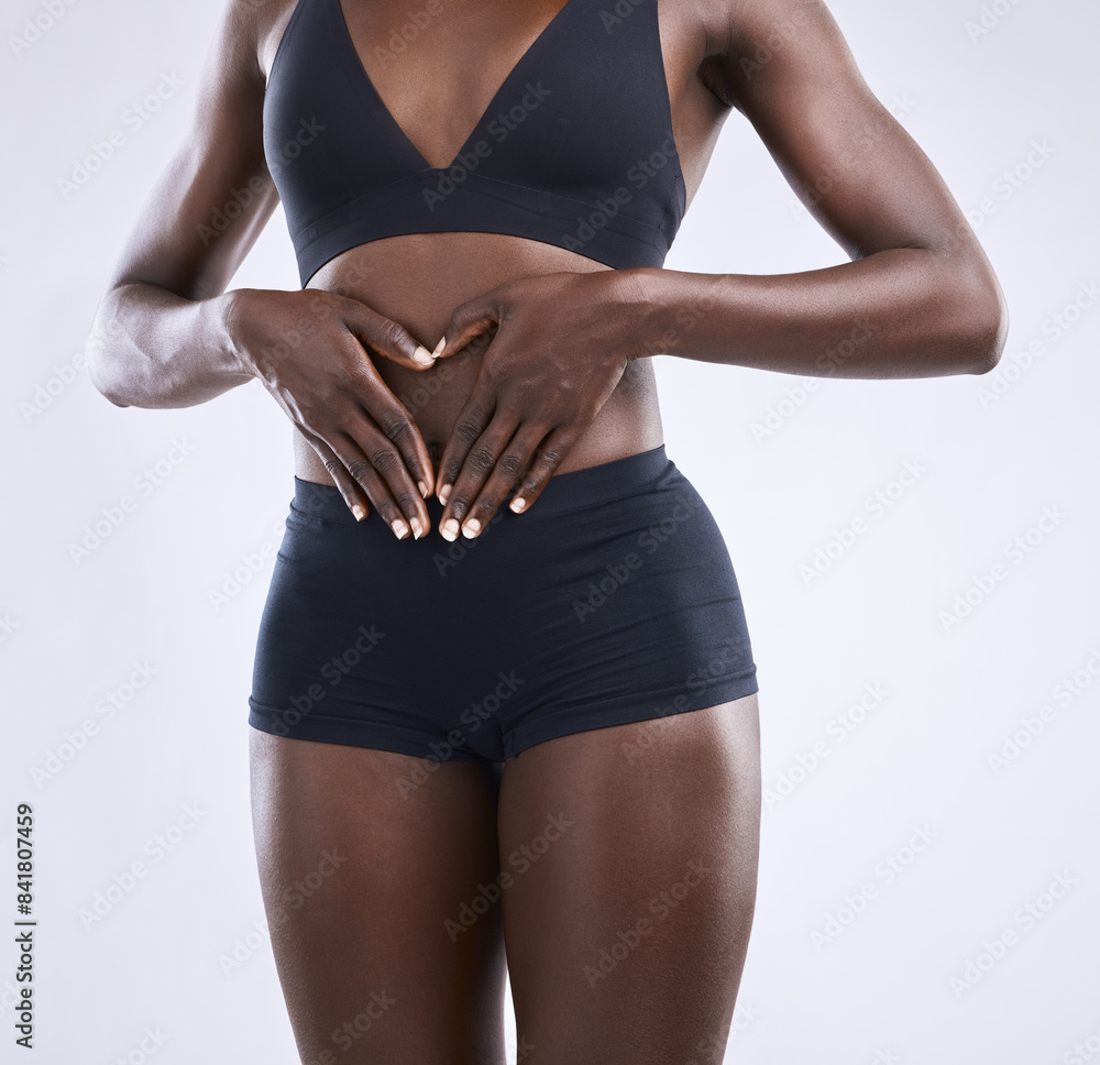 Fototapeta premium Body, stomach and heart hands by woman in studio for wellness, diet and detox, nutrition or fertility hope on white background. Gut health, self care or emoji frame for abdomen, balance or digestion