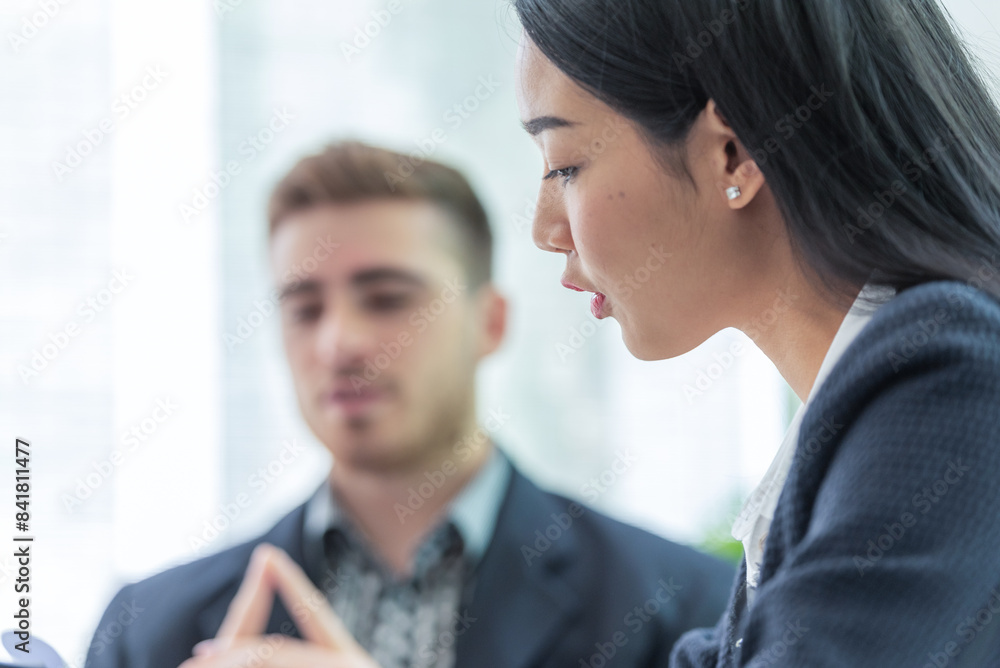 A professional woman and man are having a serious discussion in an office setting. A professional woman and man are having a serious discussion in an office setting.