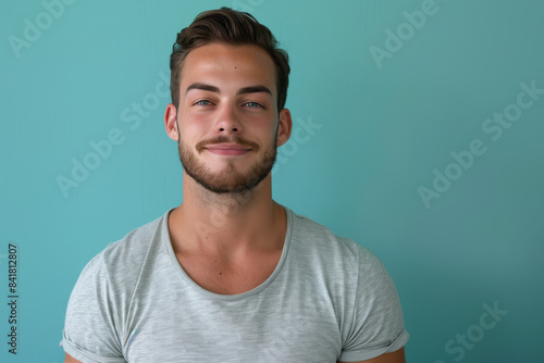 A close up portrait of a young man with a subtle smile