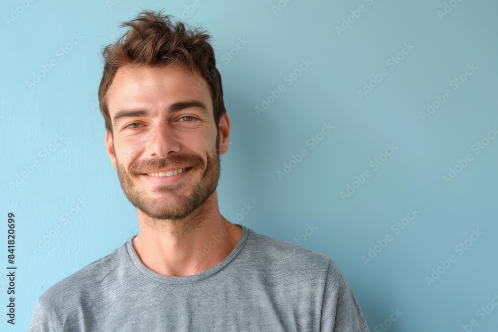 A close up portrait of a young man with a subtle smile A close up portrait of a young man with a subtle smile