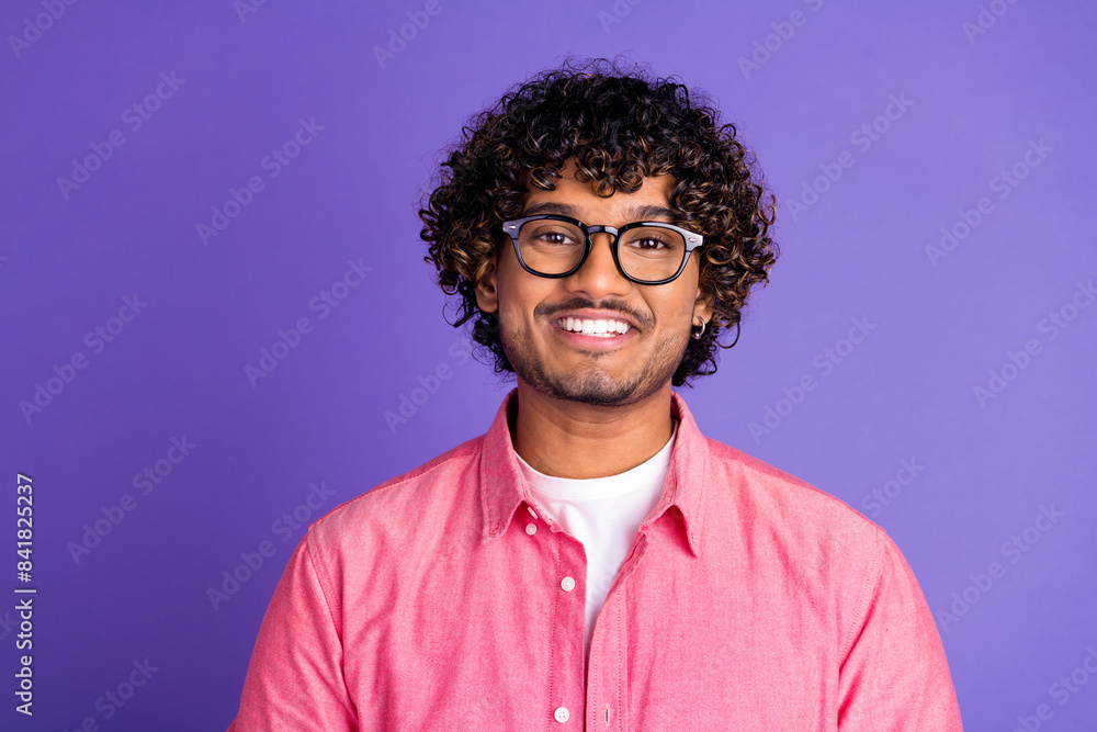 Portrait of nice young man toothy smile wear pink shirt isolated on purple color background Portrait of nice young man toothy smile wear pink shirt isolated on purple color background