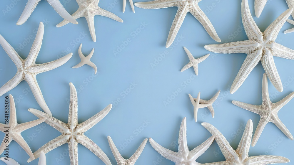 A summer beach composition of white starfish arranged in a circular pattern on a pastel blue background, evoking a sense of the ocean's rhythm. Flat lay, top view, with ample copy space. A summer beach composition of white starfish arranged in a circular pattern on a pastel blue background, evoking a sense of the ocean's rhythm. Flat lay, top view, with ample copy space.
