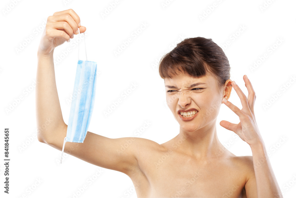 Portait of a beautiful girl holding medical face mask against viruses pollution or dust. Angry face and hand gestures Portait of a beautiful girl holding medical face mask against viruses pollution or dust. Angry face and hand gestures