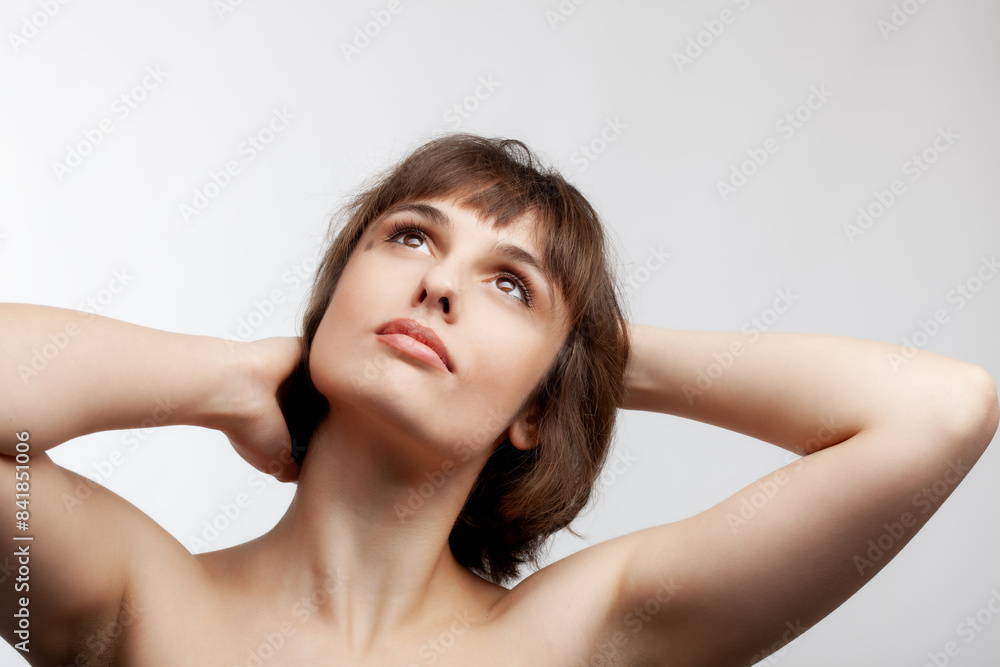 studio portrait of a beautiful brunette girl with short hair looking up isolated on white background. studio portrait of a beautiful brunette girl with short hair looking up isolated on white background.