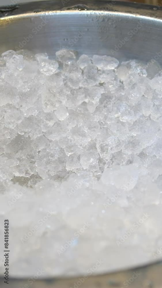 Crushed ice to collect in a glass. Pieces of ice with frozen air bubbles in the glass. Ice for a drink. Crushed ice to collect in a glass. Pieces of ice with frozen air bubbles in the glass. Ice for a drink.