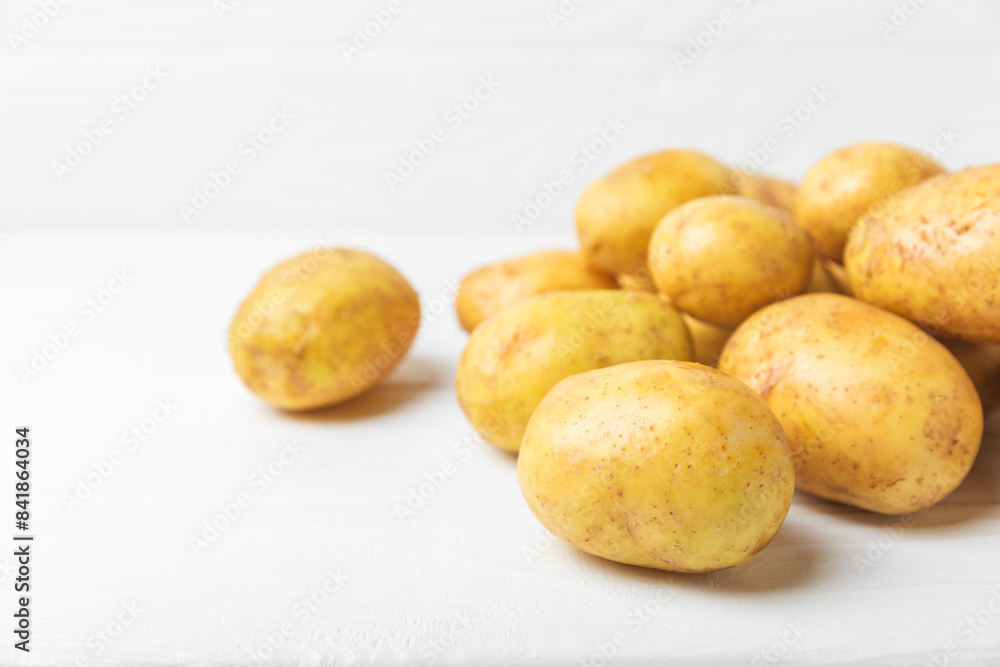 Young potatoes. Fresh potatoes on a wooden background.Harvesting collection. organic, freshly dug potatoes. Agricultural background. Vegan. Vegetables.Place for text.Copy space Young potatoes. Fresh potatoes on a wooden background.Harvesting collection. organic, freshly dug potatoes. Agricultural background. Vegan. Vegetables.Place for text.Copy space