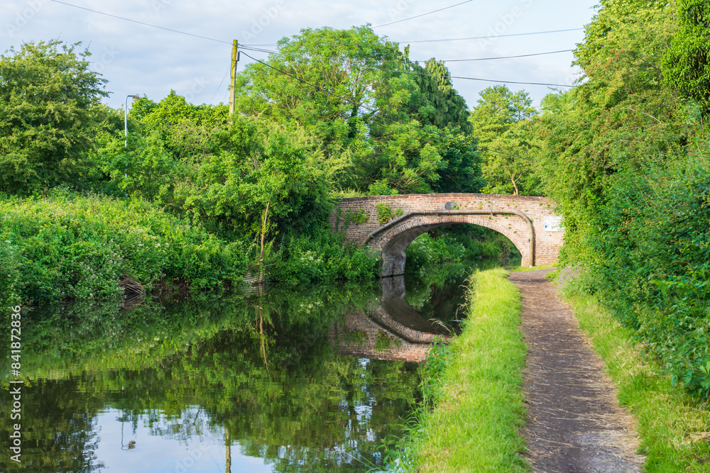 Fototapeta premium Bridge and towpath on the canal in the UK during a Spring morning