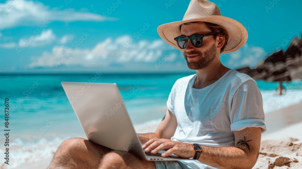 Young Man Working on Laptop While Relaxing on Tropical Beach
