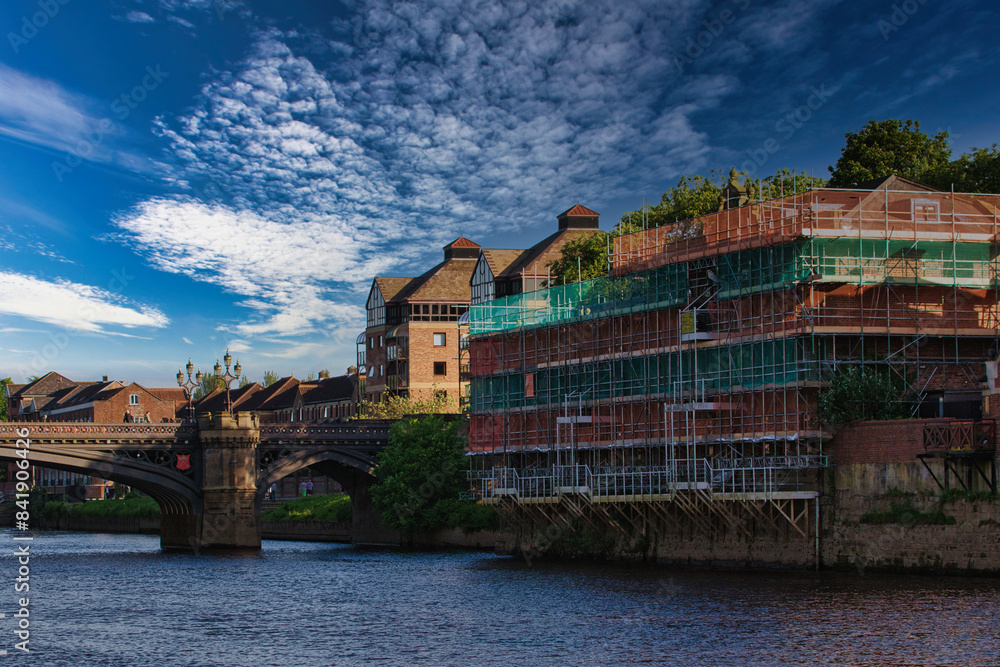 Riverside construction and bridge under a partly cloudy sky in York, North Yorkshire Riverside construction and bridge under a partly cloudy sky in York, North Yorkshire