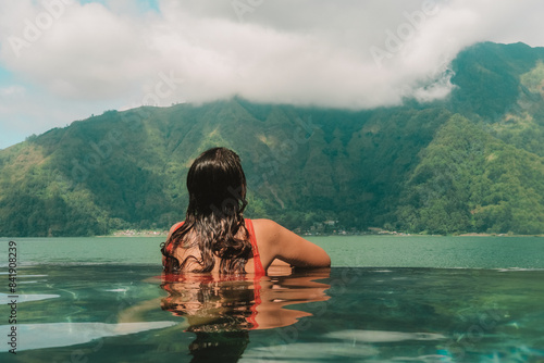 Carta da parati A young woman on vacation relaxing in the summer at hot thermal springs in a mountainous area