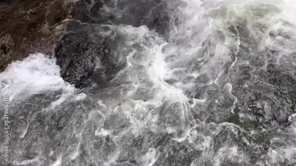 Powerful mountain river flow close-up, water in the waterfall Powerful mountain river flow close-up, water in the waterfall