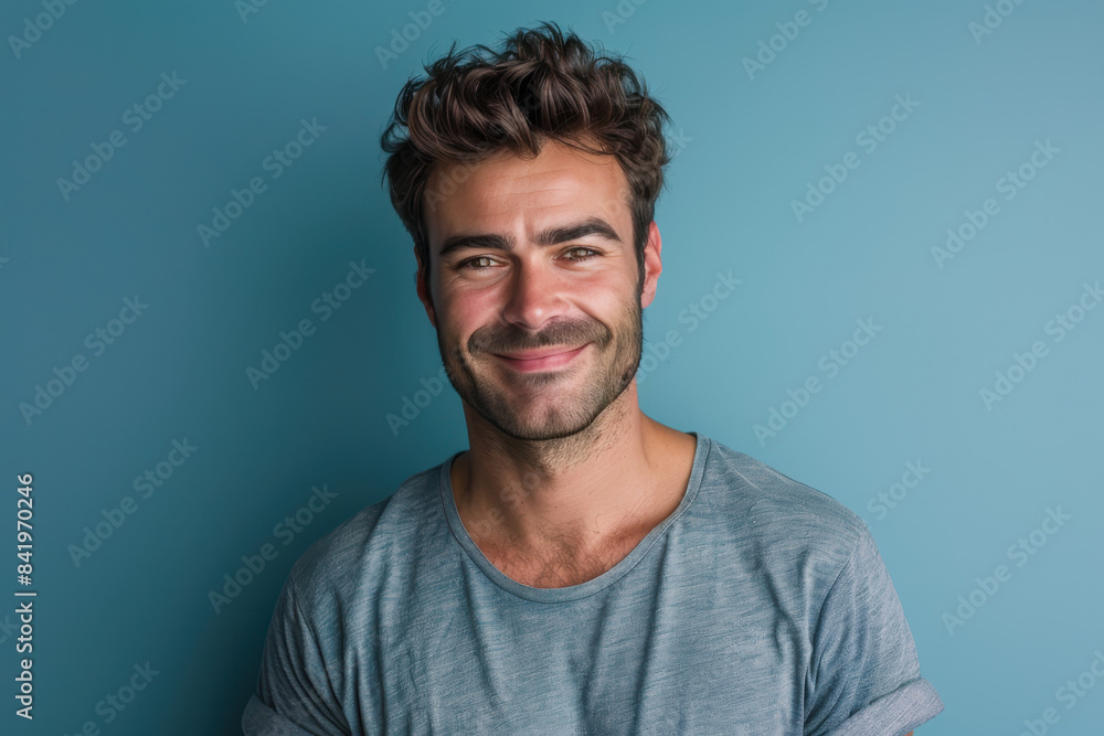 A close up portrait of a young man with a subtle smile A close up portrait of a young man with a subtle smile