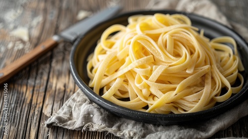 Close up image of pastafrola on a black plate with a kitchen towel on wooden surface