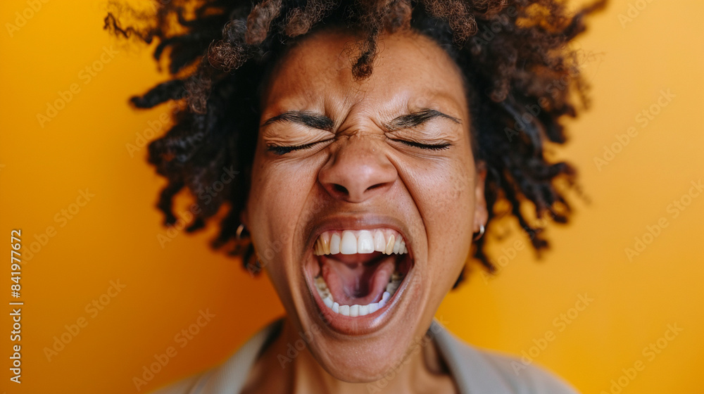 Close-up of a person's face screaming in victory with eyes closed and mouth open Close-up of a person's face screaming in victory with eyes closed and mouth open