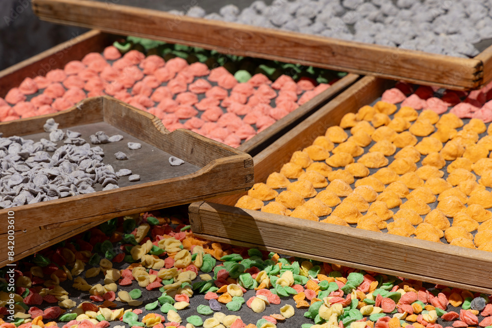 Colorful typical pasta known as orecchiette, handmade at street stands, Bari, Italy, Apulia