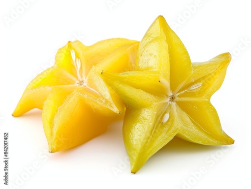 Two ripe star fruits on a white background.
