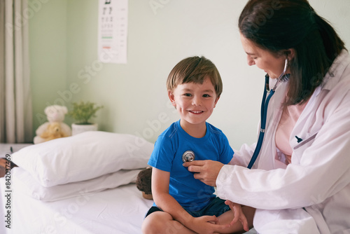 Doctor, stethoscope and child in hospital for healthcare, health and wellness with medical exam. Female pediatrician, assessment and patient in clinic for heart, lungs and cardiology with portrait photo