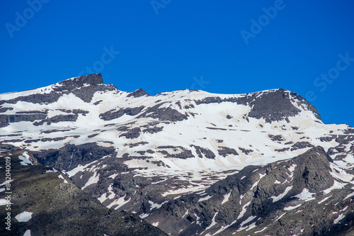 Panoramic view on snowy mountains on hiking trail to Mulhacen peak in the spring, Sierra Nevada range, Andalusia, Spain