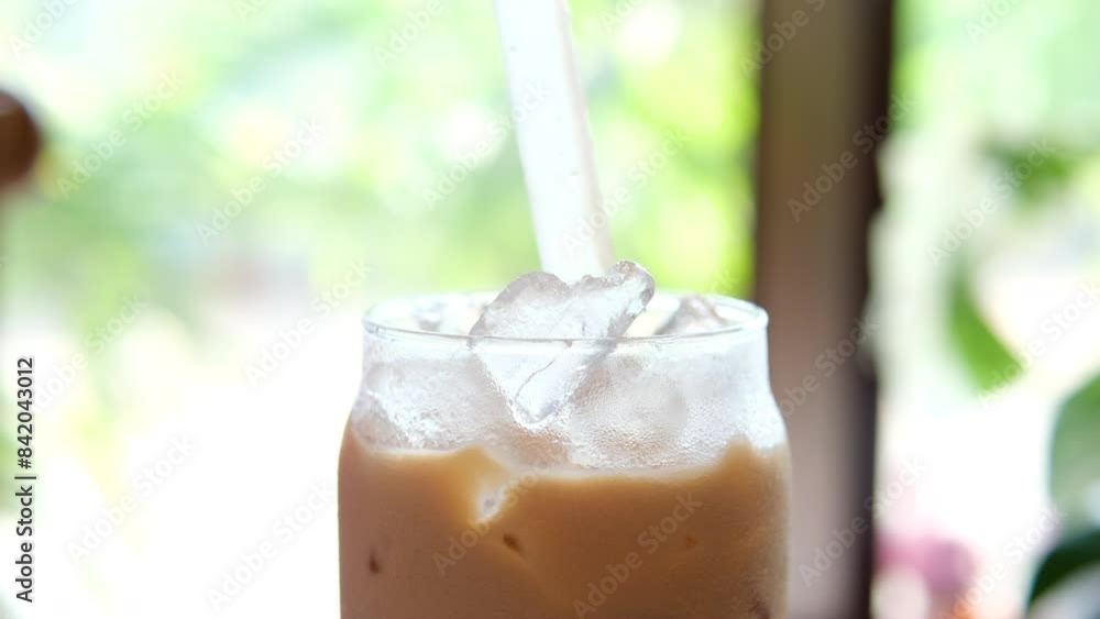 add ice Iced latte in warm weather tropical climate stir delicious drink with coffee add ice Iced latte in warm weather tropical climate stir delicious drink with coffee