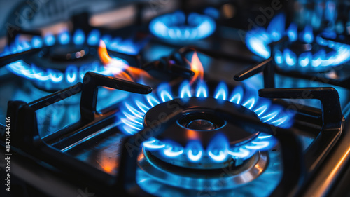 Gas burning from a kitchen gas stove. blue gas flame on hob. closeup selective focus natural