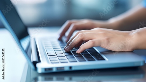 Close-up of hands typing on a laptop keyboard, representing technology, communication, and productivity in a modern workspace.