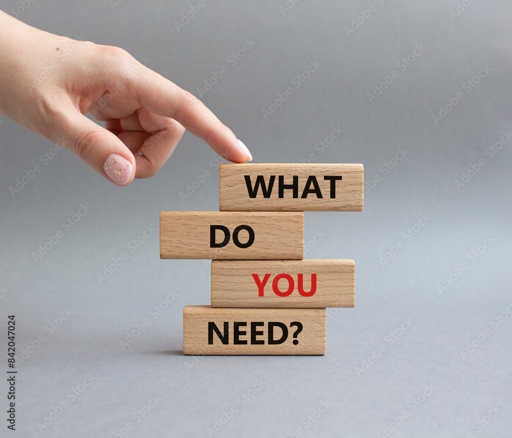 What do you need symbol. Wooden blocks with words What do you need. Businessman hand. Beautiful grey background. Business and What do you need concept. Copy space. What do you need symbol. Wooden blocks with words What do you need. Businessman hand. Beautiful grey background. Business and What do you need concept. Copy space.