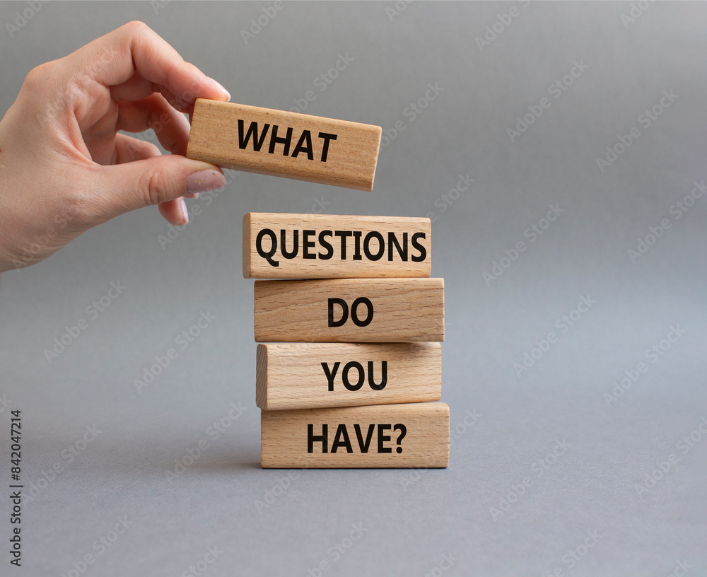 Questions symbol. Wooden blocks with words What Questions do you have. Beautiful grey background. Businessman hand. Business and What Questions do you have concept. Copy space. Questions symbol. Wooden blocks with words What Questions do you have. Beautiful grey background. Businessman hand. Business and What Questions do you have concept. Copy space.