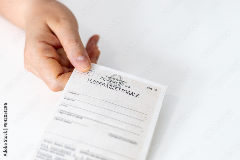 Obraz premium Hand of a voter holding an Italian Electoral Card (Tessera Elettorale)