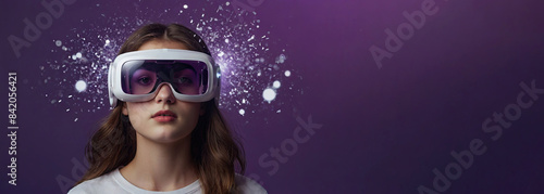 Portrait of a girl with long hair wearing virtual reality glasses on a purple background