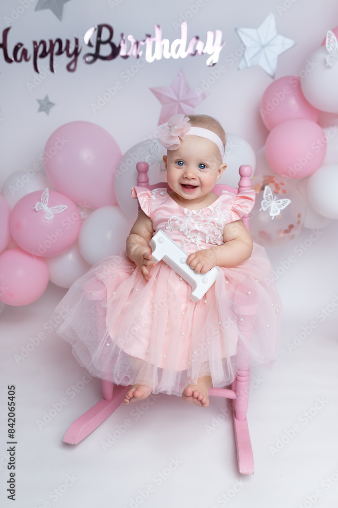 Fototapeta premium a child sitting on a background with balloons in his hands, the number 1