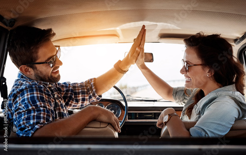 Happy couple, high five and vehicle for travel, road trip and destination achievement with smile. Car, transport and married people with hand gesture for journey goal, adventure or vacation location photo