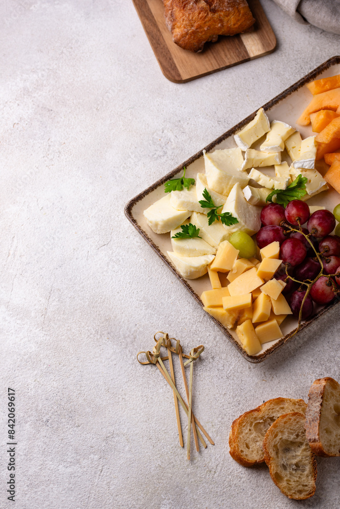 Cheese plate with different cheese, grapes and melon. Cheese plate with different cheese, grapes and melon.